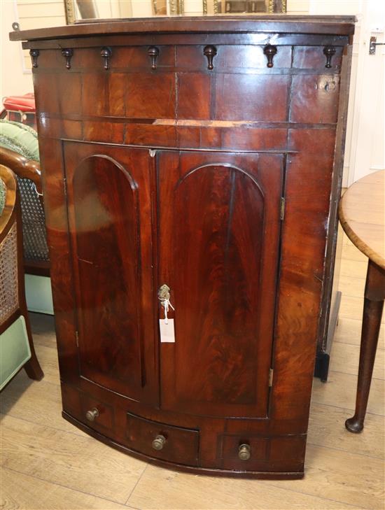 A George III mahogany bow front hanging corner cabinet W.86cm